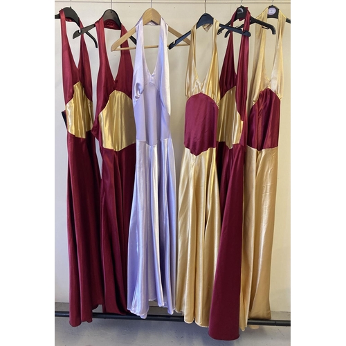 84 - 6 theatre costume satin material halter neck dresses in varying colours. With velcro fastening.