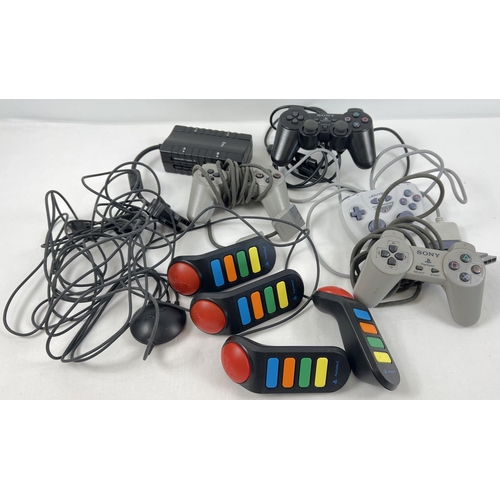 11 - A collection of vintage games console controllers. Comprising: 2 x Playstation 1 grey wired controll... 