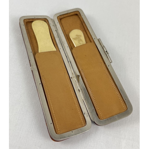 1278 - A vintage soft leather and chrome clip case containing two bone page turners. Approx. 14 cm long.