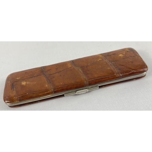 1278 - A vintage soft leather and chrome clip case containing two bone page turners. Approx. 14 cm long.