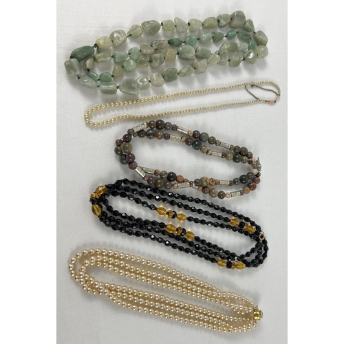1033 - A collection of vintage costume jewellery necklaces to include pearls, natural stone and glass.