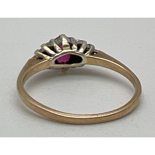 1036 - A vintage 9ct gold ruby and diamond dress ring. Central oval cut ruby with 5 small diamonds to eithe... 
