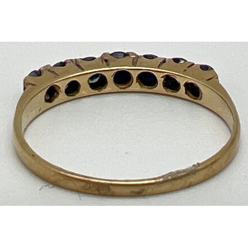 1058 - A 9ct yellow gold half eternity ring set with 7 round cut sapphires. Fully hallmarked inside band, r... 