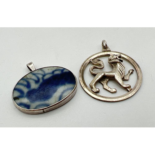 1065 - 2 vintage silver pendants. A circular shaped lion pendant, fully hallmarked to reverse, and a blue &... 