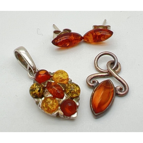 1070 - 2 silver mounted amber pendants together with a pair of marquise cut amber stud earrings. Both penda... 