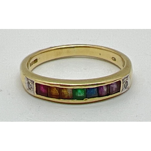 1001 - A 14ct gold ring set with 7 square cut channel set rainbow gemstones and flanked by diamonds. Gemsto... 