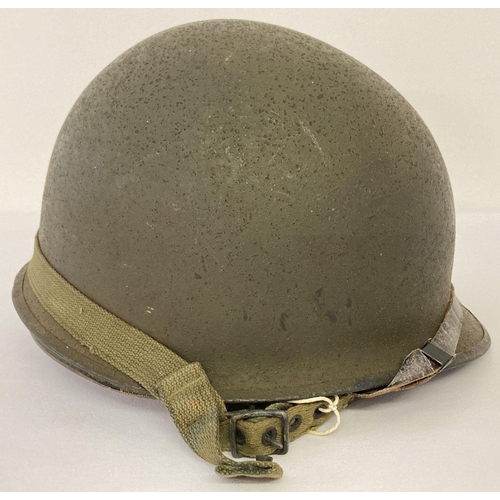 110 - Original US M1C WW2 Paratrooper helmet - 1944 specification, rear join. Complete with helmet chinstr...