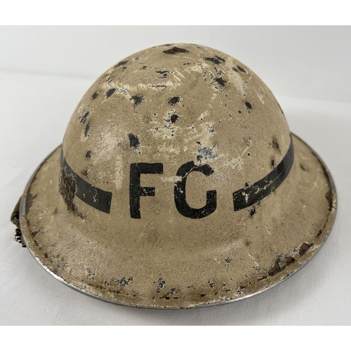 13 - WWII British MkII Home Front Fire Guard steel helmet c1939, and arm band. Painted white with circumf... 