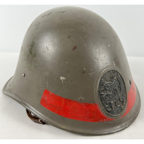 32 - A WWII Dutch M23-27 steel helmet complete with liner and chinstrap. Badge on front bearing Dutch Roy... 