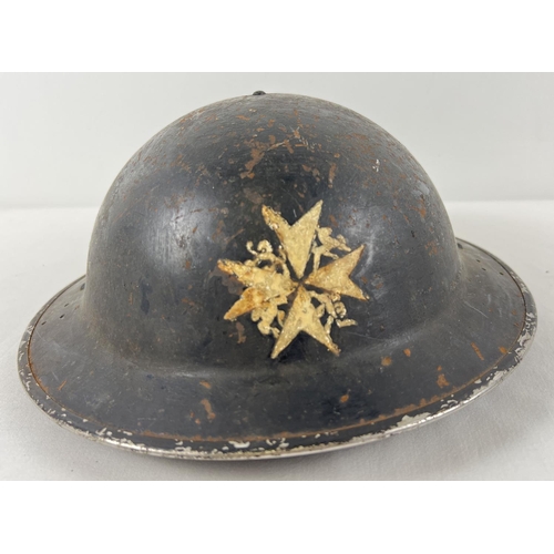 41 - A WWII British Home Front MkII No.2C steel helmet with early oval pad. Painted black with St. John A... 