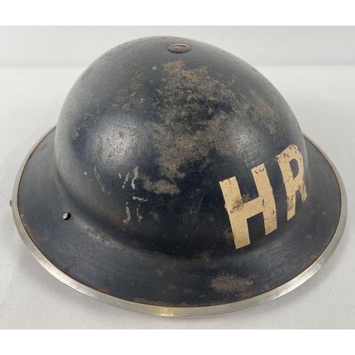 45 - A British Home Front MkII WWII steel helmet painted black and labelled in white HR for Heavy Rescue.... 