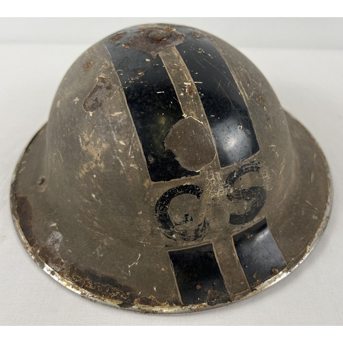 50 - A British MkII WWII Home Front steel helmet painted cream with 2 longitudinal black bands and labell... 