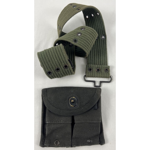 62 - A green webbing belt together with a black canvas magazine pouch with 'knip hier' catch.