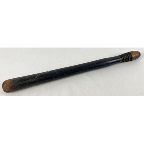 71 - A vintage ebonised wooden truncheon with ribbed design to handle. Some indistinct lettering visible,... 