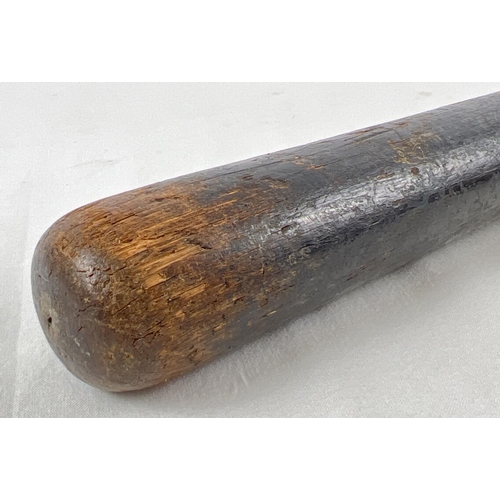 71 - A vintage ebonised wooden truncheon with ribbed design to handle. Some indistinct lettering visible,... 