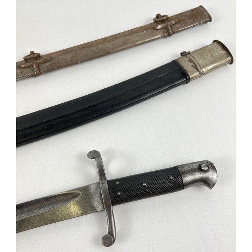 82 - An unmarked bayonette (approx. 72cm long), together with 2 curved sword scabbards.