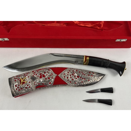 83 - A Ghurka presentation Kukri with decorative white metal overlay scabbard, in a red velvet lined case... 