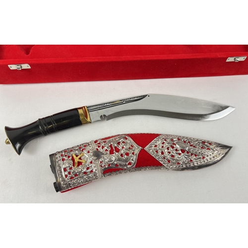 83 - A Ghurka presentation Kukri with decorative white metal overlay scabbard, in a red velvet lined case... 