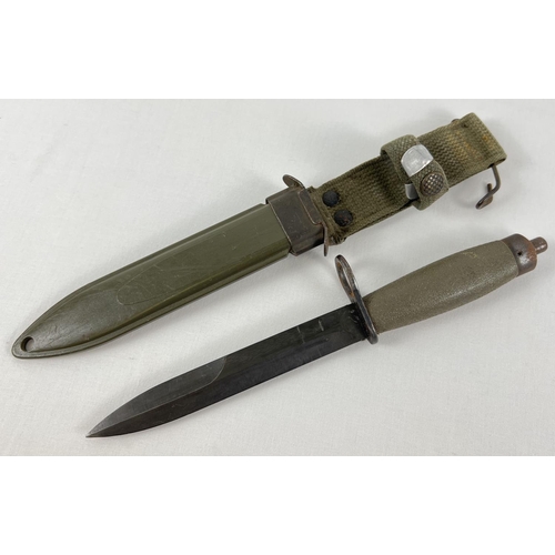94 - A 6 inch blade military bayonet knife. Complete with hard plastic and canvas scabbard with metal bel... 