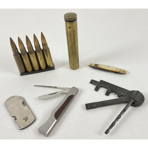 98 - A small collection of military and gun related items to include a bullet clip, brass H.S.C. oil bott... 