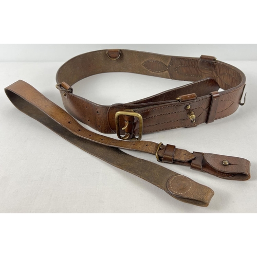 102 - A brown leather Sam Browne belt and shoulder strap with brass fixings. Belt stamped 
