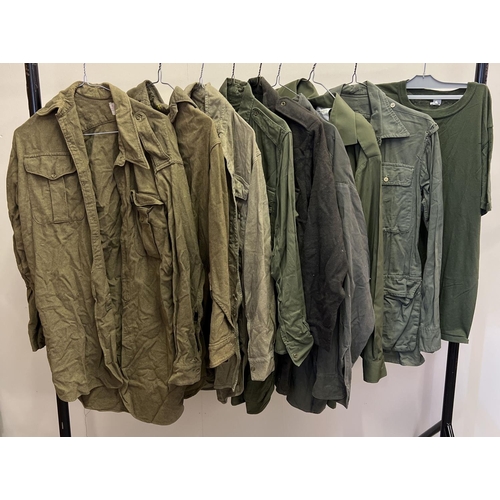 150 - 9 vintage military shirts in varying khaki greens, to include flannel and cotton examples.