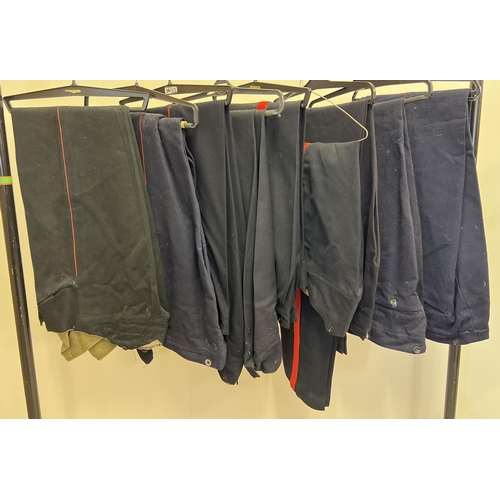 160 - 9 pairs of military style black & dark blue trousers with red leg stripes.