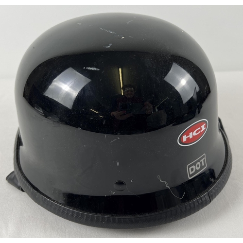 169 - A modern HCI Dot black motorcycle helmet with under chin strap and padded liner.