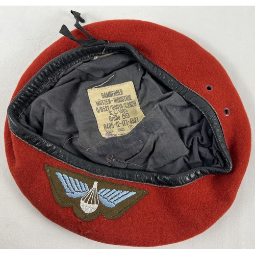 185 - A vintage German red felt beret with embroidered parachutist cloth badge. Dated 1983.