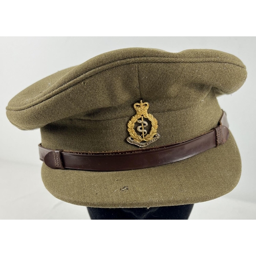 186 - A WWI style British Army peaked hat with Medical Corps cap badge and leather strap.