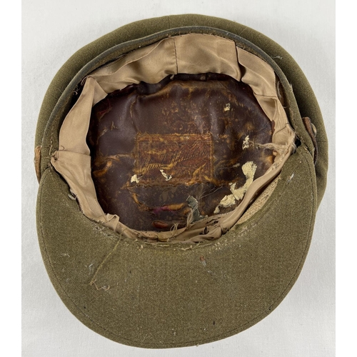 186 - A WWI style British Army peaked hat with Medical Corps cap badge and leather strap.