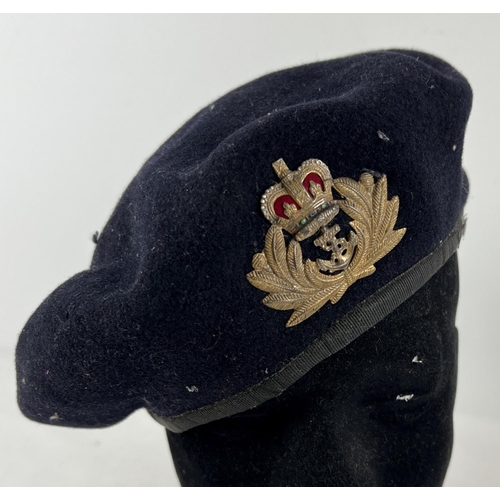 194 - A vintage Kangol felt beret with metal Navy Officers cap badge.