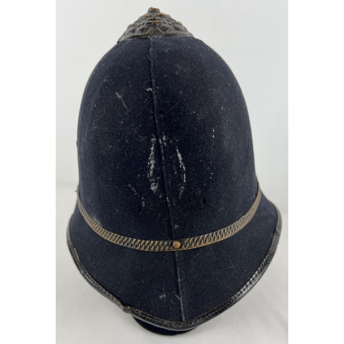 215 - A vintage Police Custodian helmet with leather strap and interior.