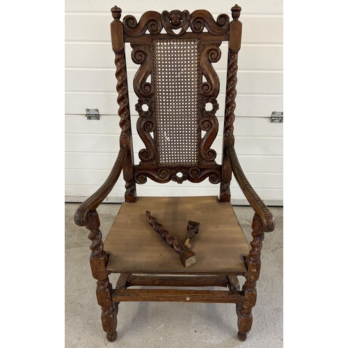 1300 - A late 17th century walnut high back armchair with barley twist columns. Carved scroll and cherub de... 