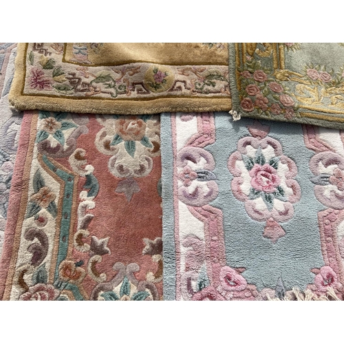 1301 - 5 Chinese style rugs with floral detail, in varying colours and sizes. To include pink ground runner... 