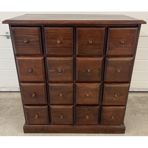 1316 - A vintage dark wood 16 drawer chest. With square shaped drawers and wooden knob handles. Approx. 85c... 