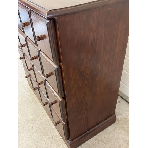 1316 - A vintage dark wood 16 drawer chest. With square shaped drawers and wooden knob handles. Approx. 85c... 