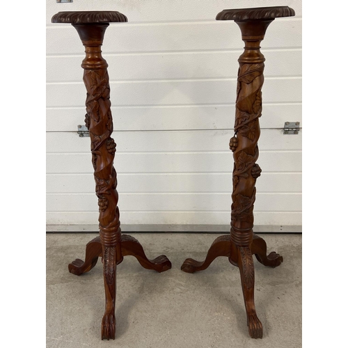 1317 - A pair of mahogany 3 footed torcheres with carved detail. Twisted pedestal stems with grape & vine c... 