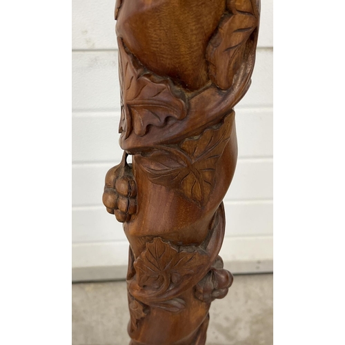 1317 - A pair of mahogany 3 footed torcheres with carved detail. Twisted pedestal stems with grape & vine c... 