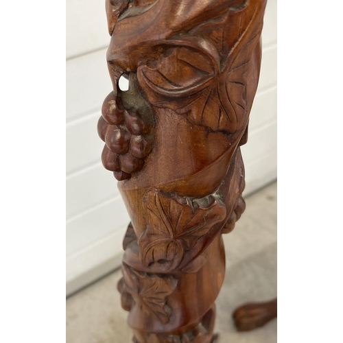 1317 - A pair of mahogany 3 footed torcheres with carved detail. Twisted pedestal stems with grape & vine c... 