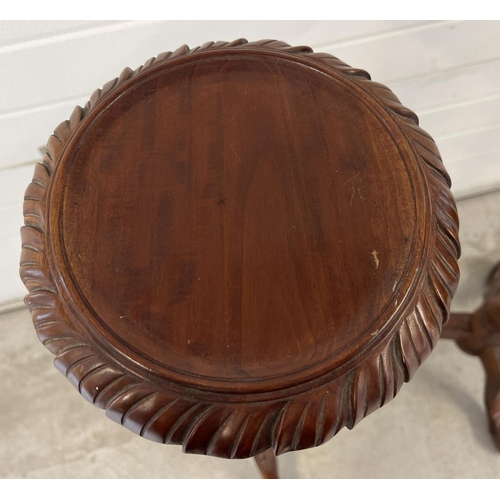 1317 - A pair of mahogany 3 footed torcheres with carved detail. Twisted pedestal stems with grape & vine c... 