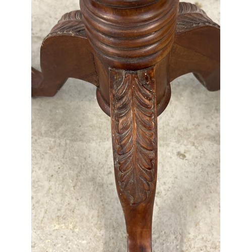 1317 - A pair of mahogany 3 footed torcheres with carved detail. Twisted pedestal stems with grape & vine c... 