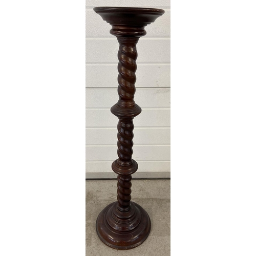 1318 - A modern mahogany coloured torchere with twist stem design. Approx. 98cm tall, diameter of circular ... 