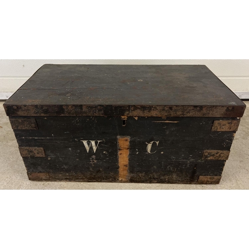 1319 - A vintage pine box, painted black with metal banded corners and lid edging. Painted 'W.C' monogram t... 