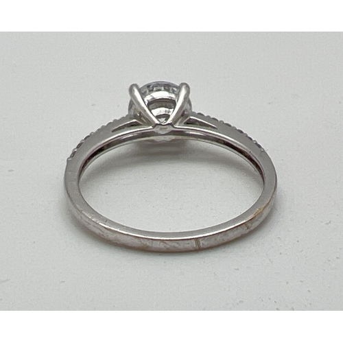 1027 - A 9ct white gold dress ring set with cubic zirconia stones. Central round cut stone with 6 small rou... 