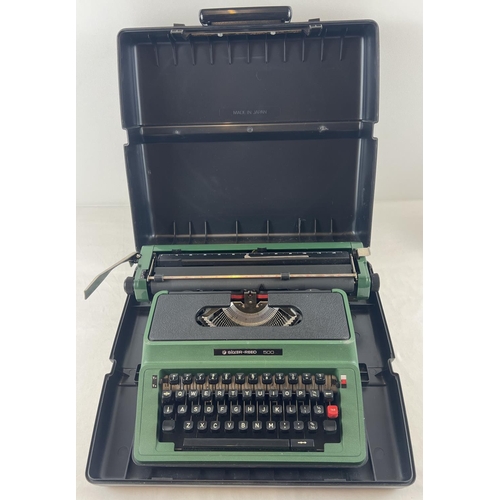 1251 - A vintage greem Silver-Reed 500 typewriter complete with carry case.