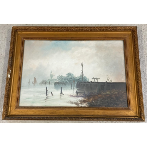 1283 - A gilt framed and glazed oil painting of a riverside scene on a misty morning, unsigned. Frame size ... 