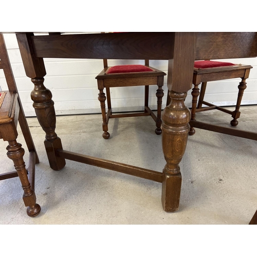 1328 - A vintage medium oak drop leaf table with shaped legs together with 6 dining chairs with red and gol... 