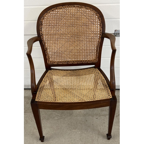 1331 - An Edwardian mahogany arm chair with re-caned seat and shaped back. With shaped arms and tapered fro... 