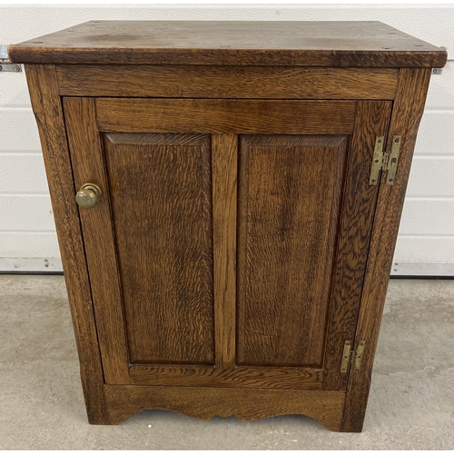 1282 - A vintage dark oak cupboard with brass knob handle and interior shelf. Panelled door with push catch... 